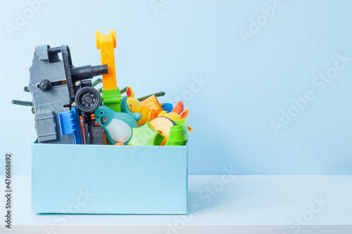 Box with old plastic toys for donate or recycle. Copy space.