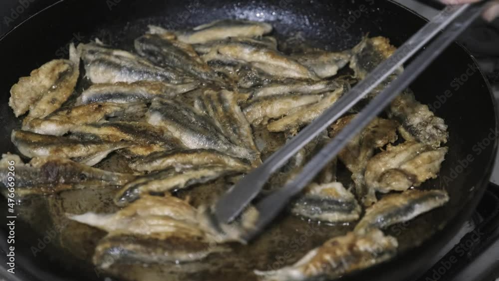 Cooking anchovies in oil. Fried anchovies in a pan. Cooking anchovies