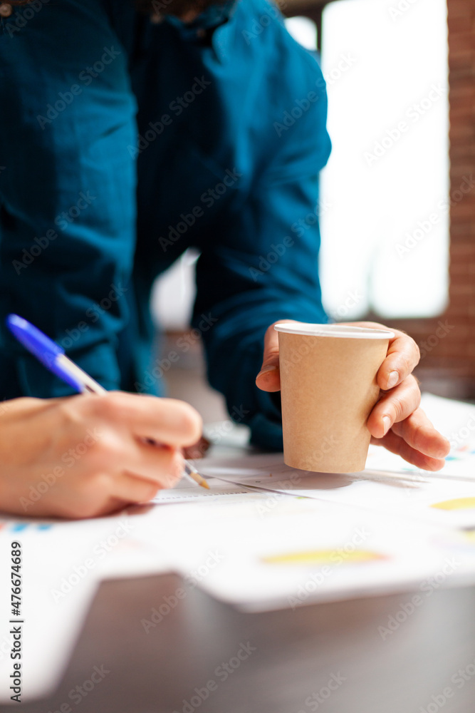Closeup of businesswoman hand explaining management strategy to manager man analyzing company paperworks in startup office. Businesspeople working at marketing project planning business meeting Closeup of businesswoman hand explaining management strategy to manager man analyzing company paperworks in startup office. Businesspeople working at marketing project planning business meeting