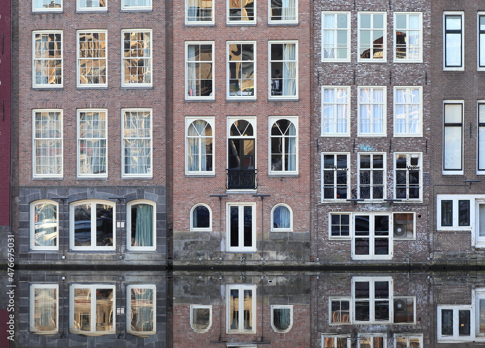 Amsterdam Damrak Canal Traditional House Facades with their Reflection in the Water, Netherlands