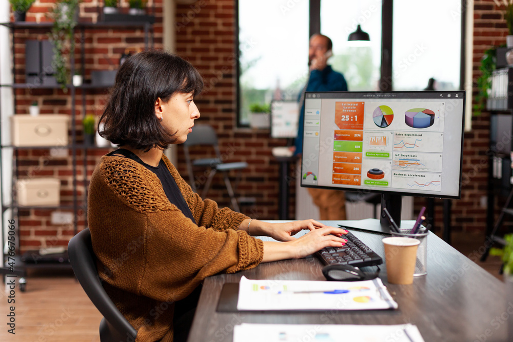 Entrepreneur looking at computer screen analyzing digital marketing graphs working at management strategy in startup office. Executive manager planning business meeting searching company solution Entrepreneur looking at computer screen analyzing digital marketing graphs working at management strategy in startup office. Executive manager planning business meeting searching company solution