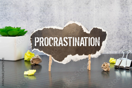 Procrastination word cloud concept. word Procrastination on black torn paper photo