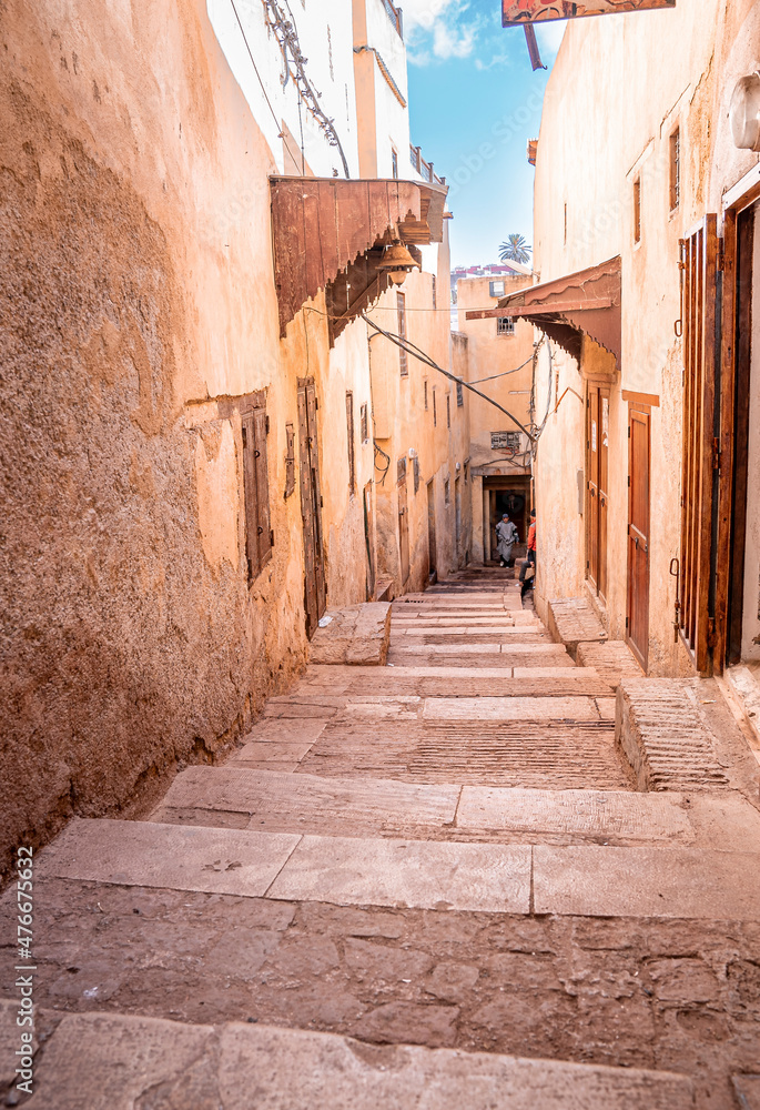 Narrow old alley of stone flooring staircase with residential structure on both side