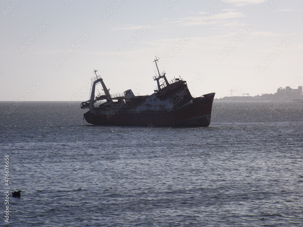 Ship aground on the coast of the bay of Montevideo.
A semi sunken fishing boat in the bay of Montevideo with the sky in the background at sunset.