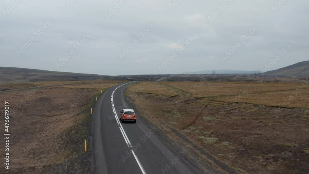 Birds eye of majestic Iceland landscape with car driving rock highlands. Aerial view 4x4 vehicle driving ring road exploring icelandic countryside. Adventure and exploration. Commercial insurance
