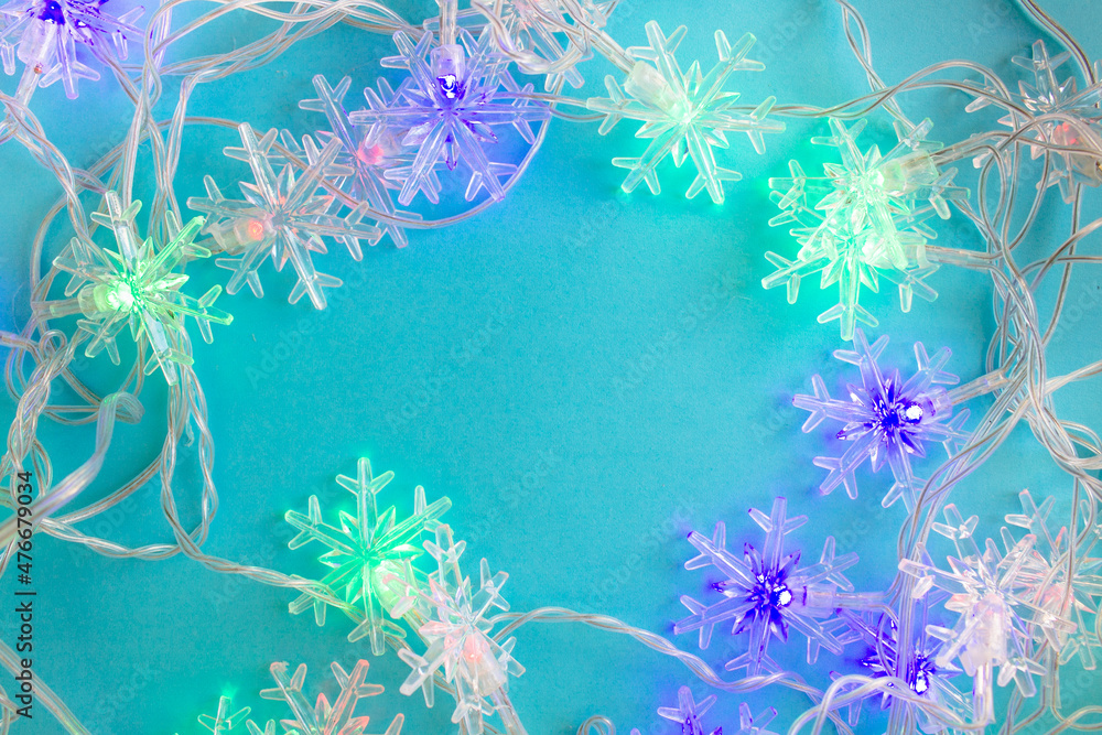 garland with snowflakes on a blue background. Festive background. garland with snowflakes on a blue background. Festive background.