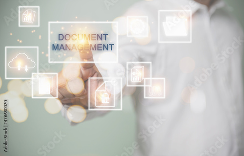 Concept of business document management system, change of document management, business process, business, and technology concept. Businessman touching virtual screen access document system.