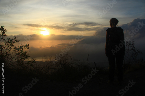 A woman standing at the top of mount Batur in Bali Indonesia.