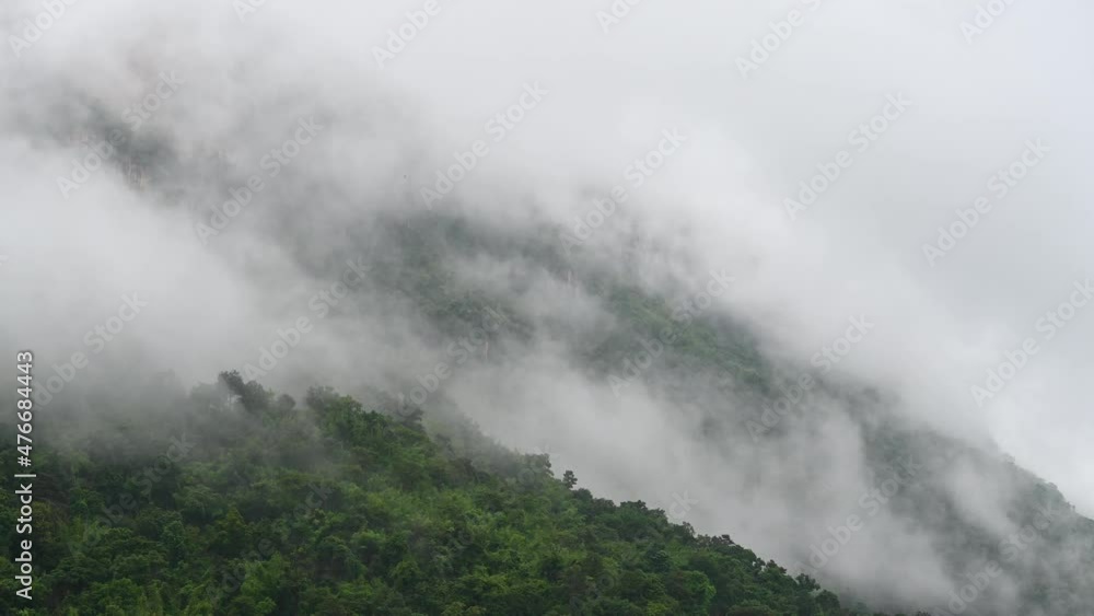 Fog moving fast going up the mountain slope after a heavy rain in Sai Yok province in Kanchanaburi, Thailand. Fog moving fast going up the mountain slope after a heavy rain in Sai Yok province in Kanchanaburi, Thailand.