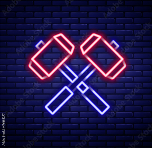 Glowing neon line Medieval crossed battle hammers icon isolated on brick wall background. Colorful outline concept. Vector