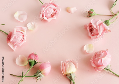 Flowers background.Pink roses frame top view on pink background with copy space. Poster