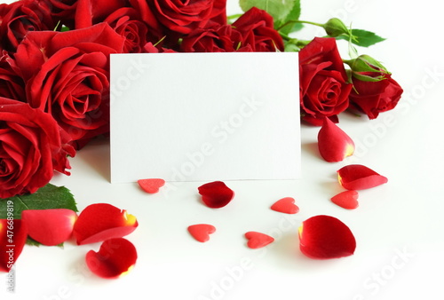 Red roses with a blank gift tag background banner. Holiday concept.