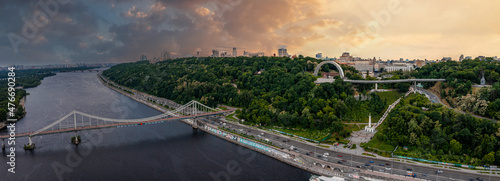 Panoramic view of Kyiv from the sky. Sunset over summer Kiev with Arch of Friendship of Peoples. Aerial view