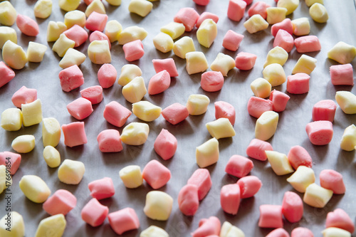 Colorful pillow mints made from scratch at home; butter mints spread out on a pan