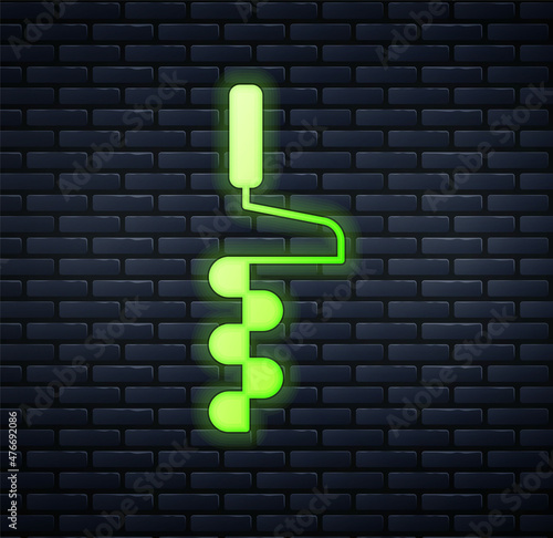 Glowing neon Hand ice drill for winter fishing icon isolated on brick wall background. Vector