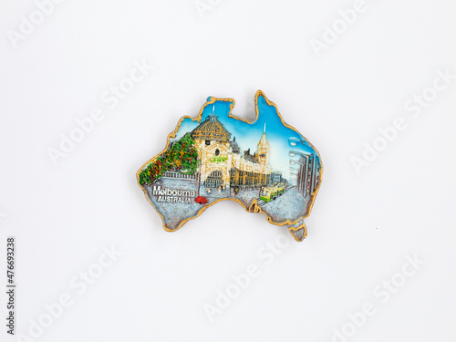 Fridge magnet in form of Australia country with decorative inscription Melbourn isolated on white background. Travel to Australia concept. Top view flat lay, close up