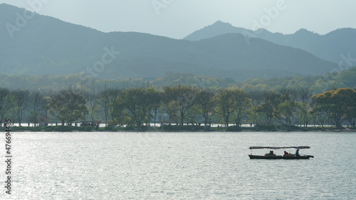 The beautiful lake landscapes in the Hangzhou city of the China in spring with the peaceful lake and fresh green mountains