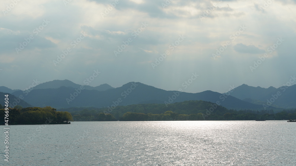 The beautiful lake landscapes in the Hangzhou city of the China in spring with the peaceful lake and fresh green mountains