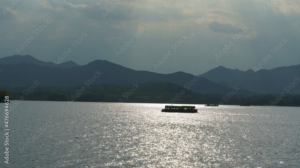 The beautiful lake landscapes in the Hangzhou city of the China in spring with the peaceful lake and fresh green mountains The beautiful lake landscapes in the Hangzhou city of the China in spring with the peaceful lake and fresh green mountains
