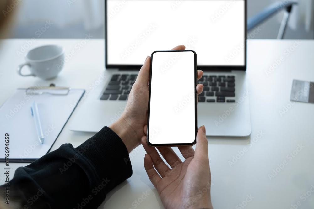 Close up view businesswoman holding mock up smart phone with blank screen. Close up view businesswoman holding mock up smart phone with blank screen.
