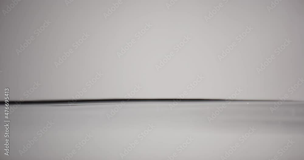 Water Surface Moving Up And Down Against White Background Water Surface Moving Up And Down Against White Background