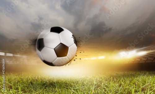 Soccer ball under the spot ray light effects on green field in 3D illustrations, of free space for texts and branding. © DESIGN STOCK