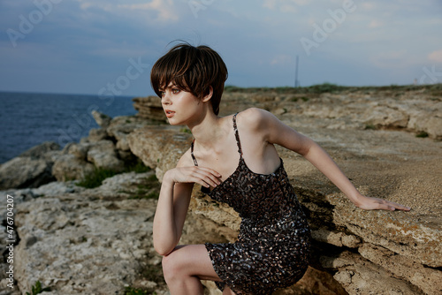 pretty woman in dress on nature rocks landscape outdoors unaltered
