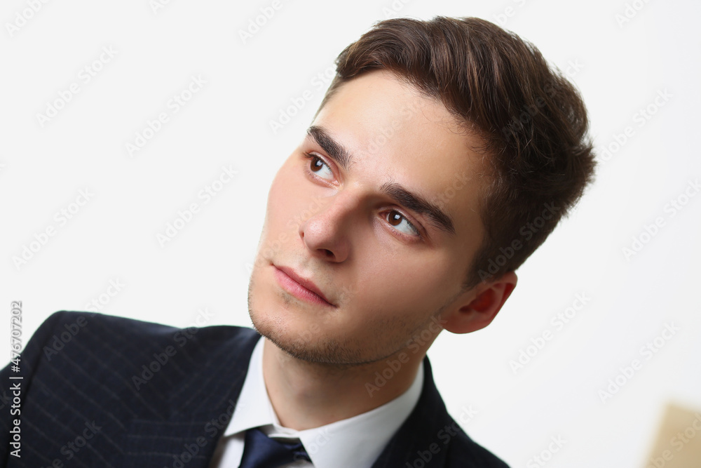 Handsome young man looking away, pensive look, thoughtful mood Handsome young man looking away, pensive look, thoughtful mood