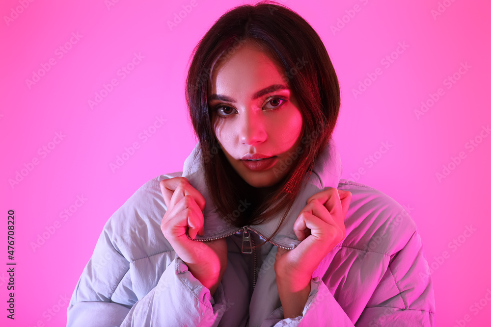 Pretty young woman in stylish warm clothes on color background Pretty young woman in stylish warm clothes on color background