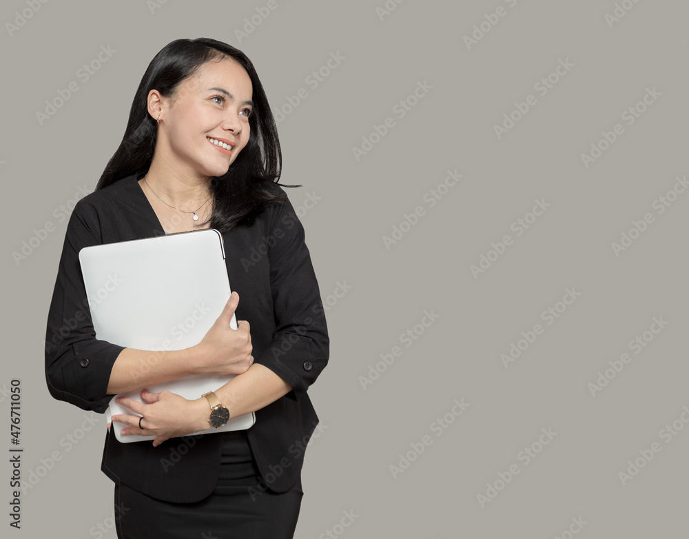 Beautiful business woman hugging laptop and looking at empty space Beautiful business woman hugging laptop and looking at empty space
