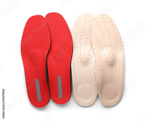 Different orthopedic insoles on white background