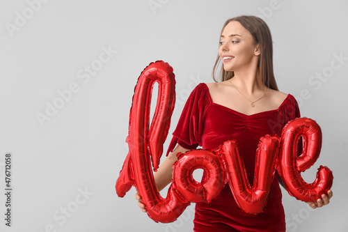 Smiling young woman in red ...