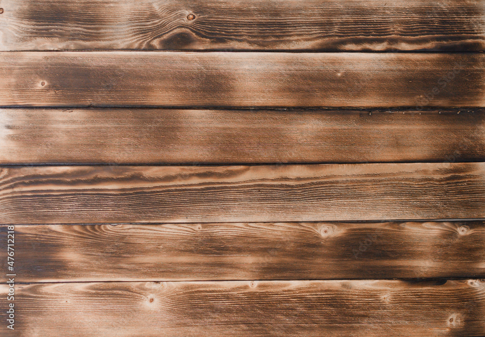 Fototapeta premium brown burnt boards. the background is made of natural wood.