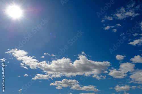 photograph of the sky  the region of the atmosphere and space  visible from the earth. sun-lit clouds  illuminated by direct light from the sun.