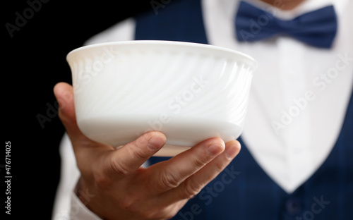 Waiter with a white plate in his hand