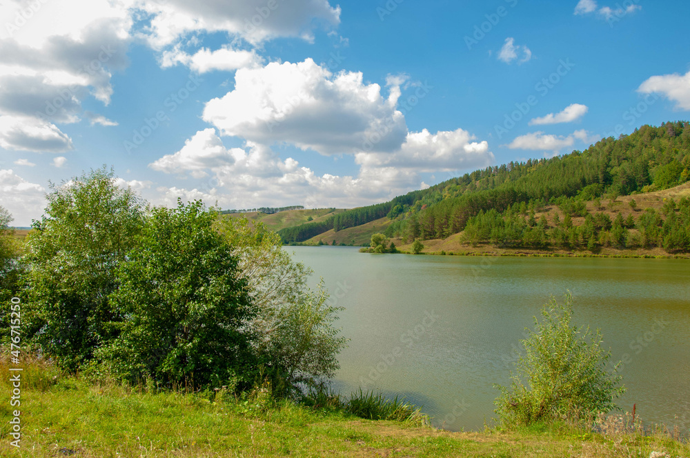 Summer landscape photography, rolling hills with a lake, Central Europe