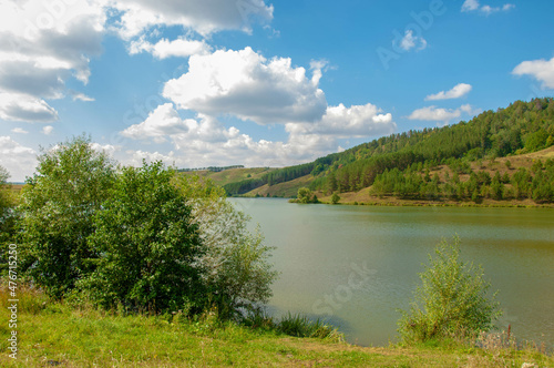 Summer landscape photography, rolling hills with a lake, Central Europe