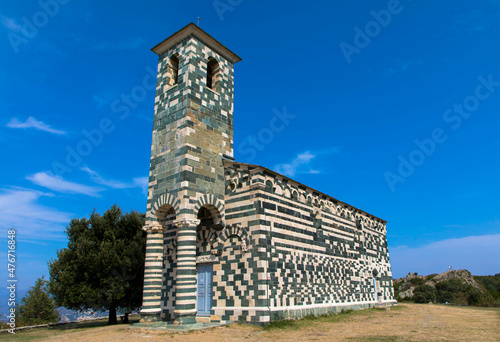 View of the famous Church of San Michele de Murato, a small chapel in polychrome stones and typical pisan romanesque style in village of Murato, Haut-Corse, France photo