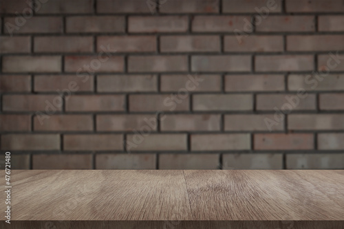 Wooden board empty table in front of light brick wall background. Background blurred. Mock up for display of product