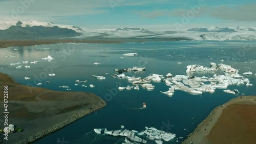 Jokullsarlon glacial lake in southwest Iceland. Aerial view of icebergs in the lagoon, going down from the sky photo
