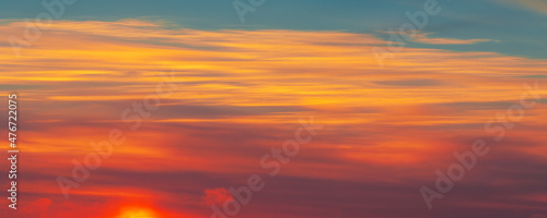 Photo of the sky with clouds, sunrises, sunsets, orange-yellow tones from the setting sun © Татьяна Мищенко