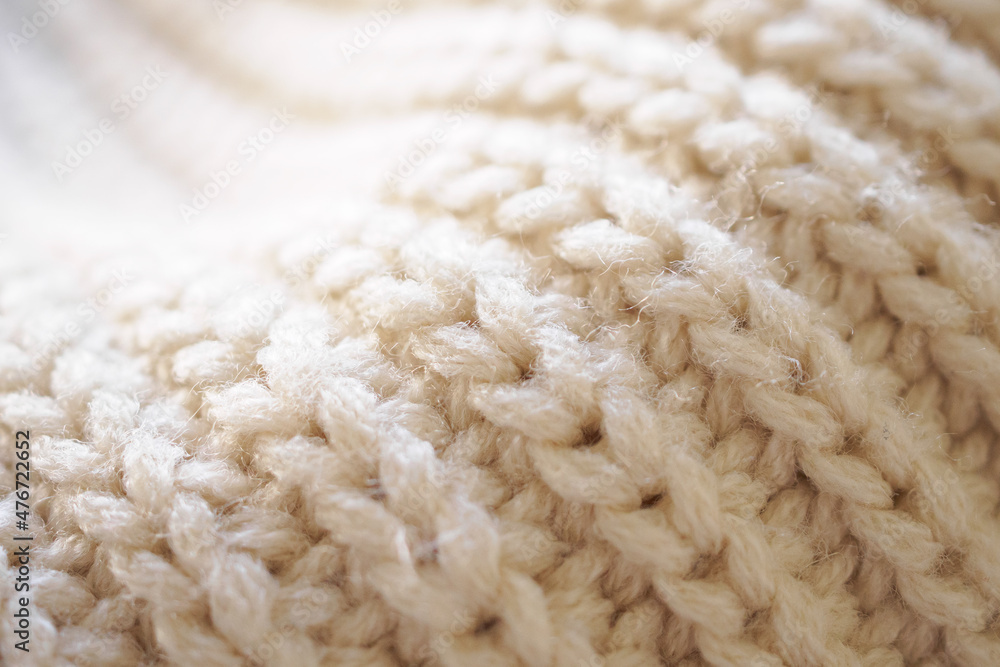 closeup beige knitted woolen fabric texture background closeup beige knitted woolen fabric texture background