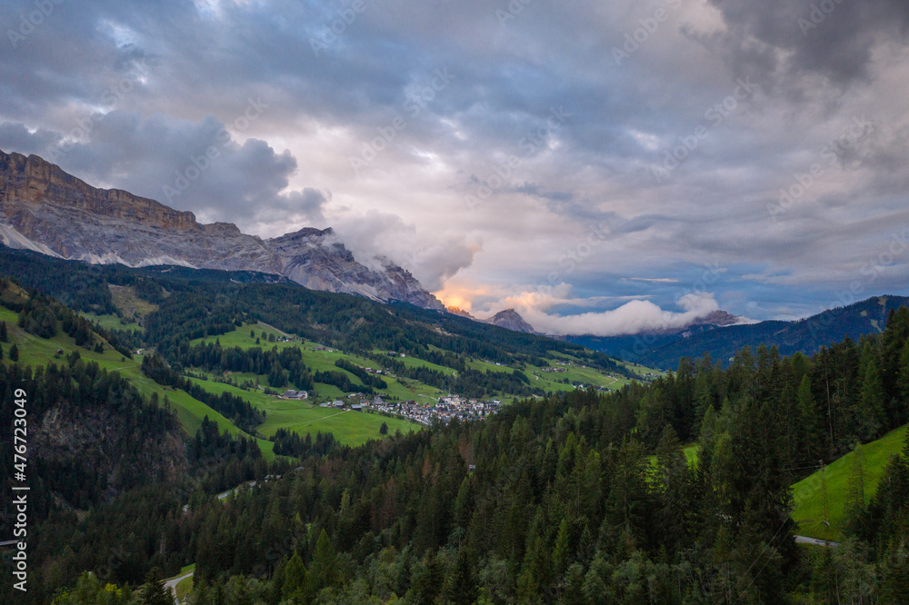 aerial view on sunset in the cloudy dolomites mountains