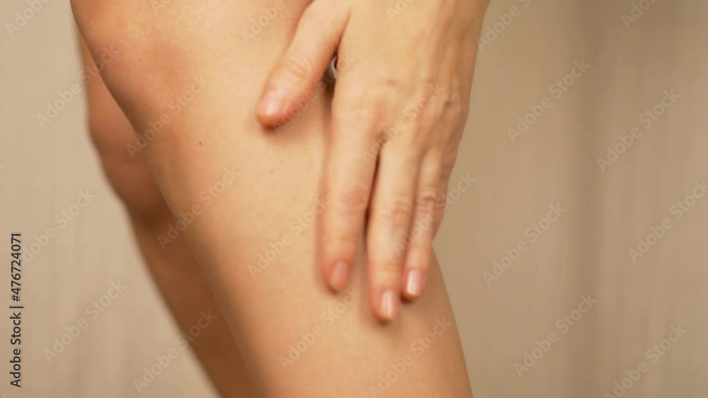 Legs Skin Care. Girl Rubs Cream into the Shin and Massages the Leg, Slow Motion, Close-up. Legs Skin Care. Girl Rubs Cream into the Shin and Massages the Leg, Slow Motion, Close-up.