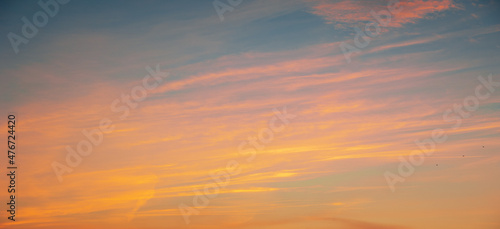 Photo of the sky with clouds, sunrises, sunsets, orange-yellow tones from the setting sun