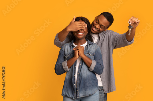 New Home. Loving Black Husband Holding Keys And Covering Wife's Eyes