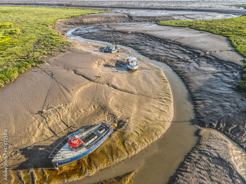 Small fishing boats moored in the Stone Creek inlet at Sunk Island, East Yorkshire, UK photo