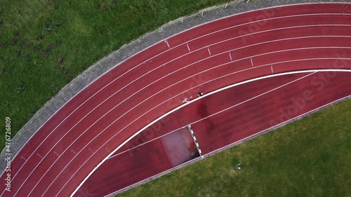 women athlete runners on track seen from above. Drone aerial shot