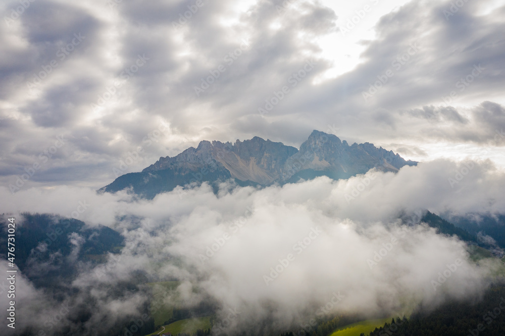 aerial view on latemar mountains covered in clouds