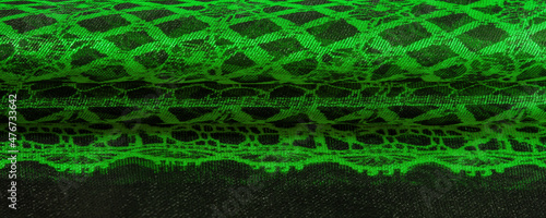 Texture, background, pattern. Emerald green lace fabric, a combination of green with black fabric. verdant, lawny, virid, vealy photo